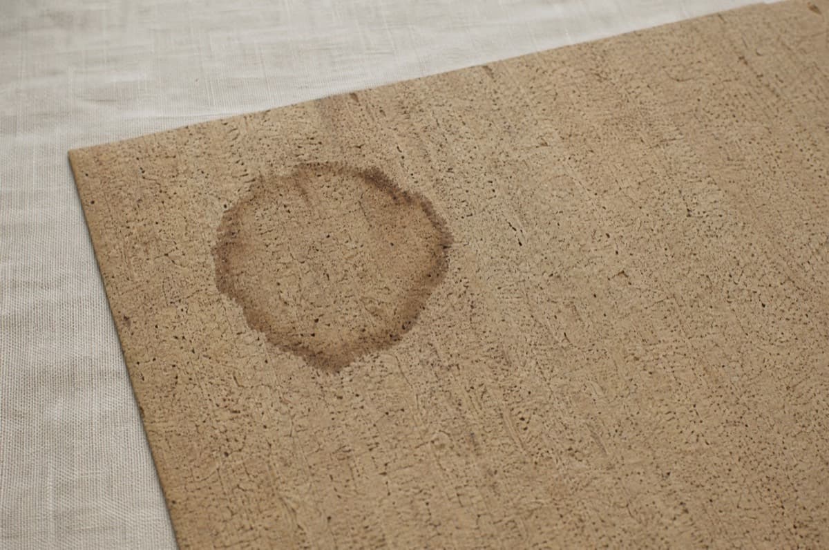 A water ring soaked into cork fabric. It stays.