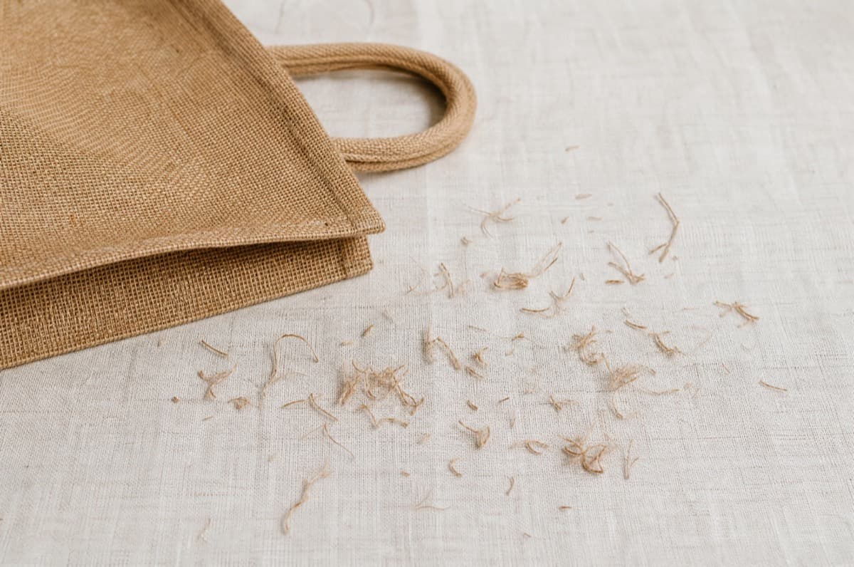 Short fibres shed from an unlined jute tote in its first week.