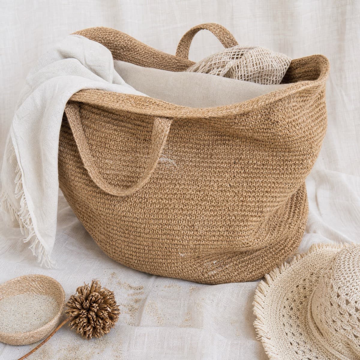 An oversized jute beach tote with a wide open mouth