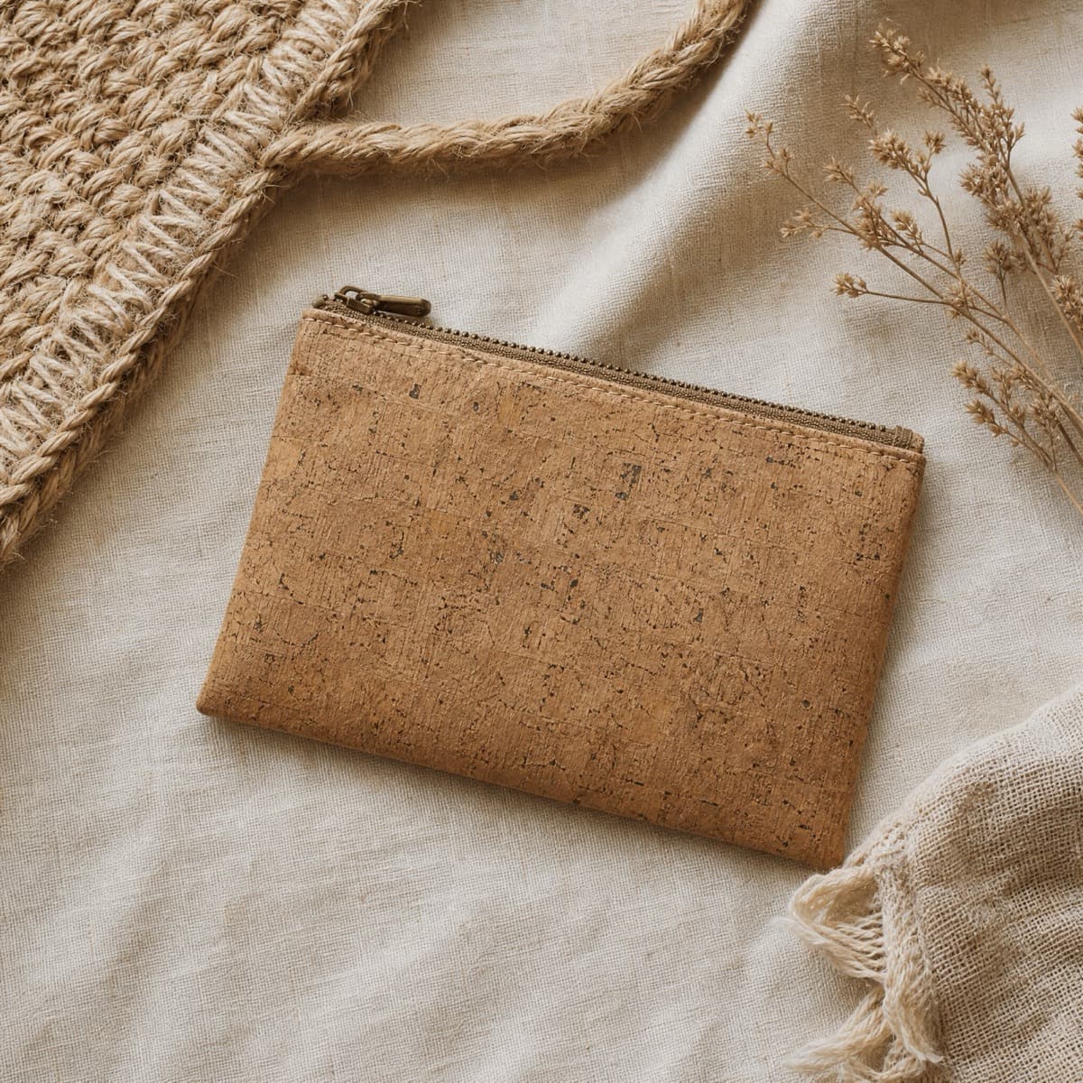 A flat cork fabric pouch with a top zip
